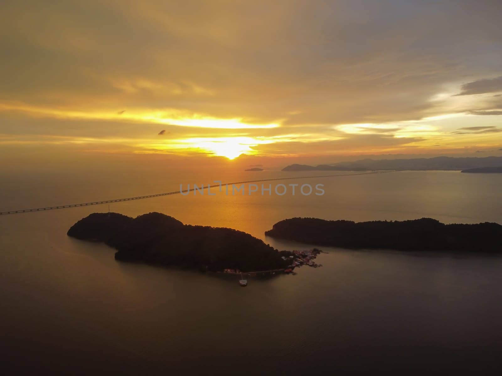 Aerial view dramatic sunset cloud over Pulau Aman Island with Penang Second Bridge as background
