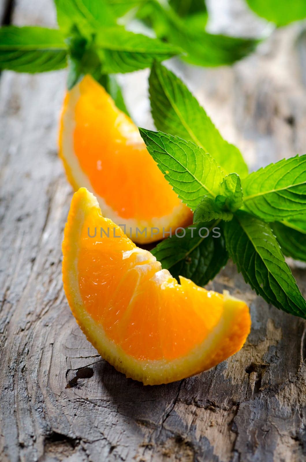 Orange and fresh mint on rustic wooden table