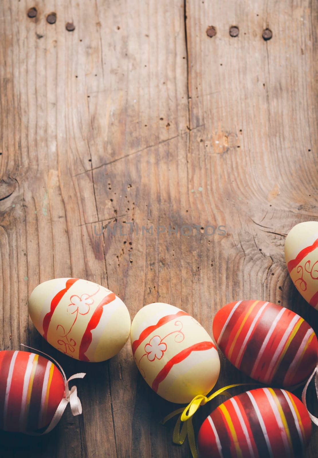 Easter eggs on rustic wooden table in retro style.