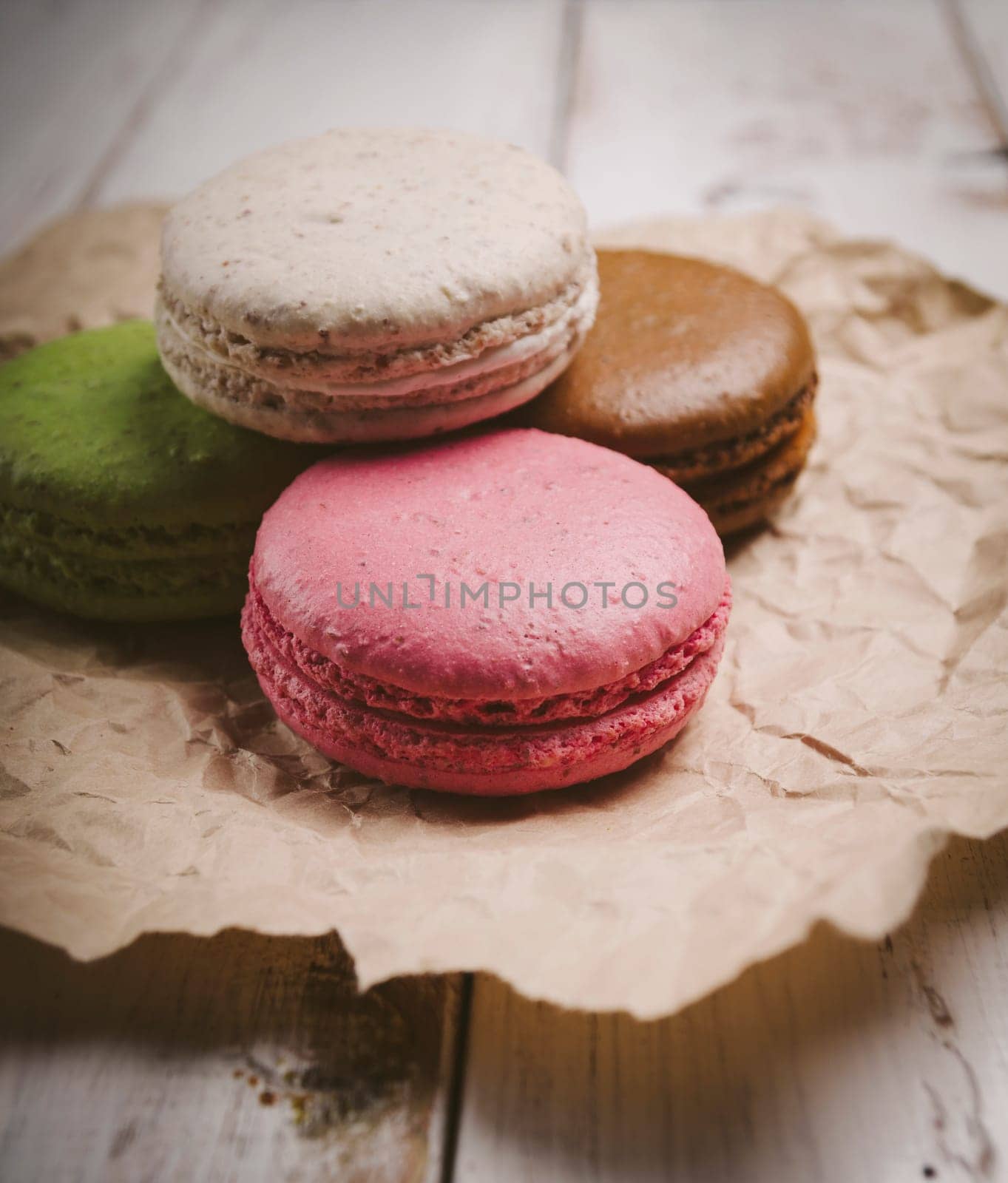 Colorful macaroons on craft paper. Retro filter.