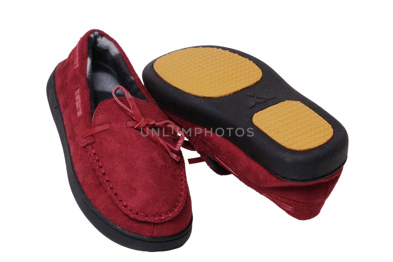 Slippers isolated. Close-up of a pair of female red warm and soft cosy terry slippers with non-slip sole isolated on white background.  Shoes of a woman. Macro.