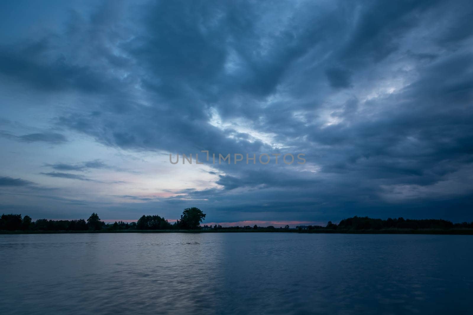 Cloudy evening sky over a calm lake, Stankow, Lubelskie, Poland