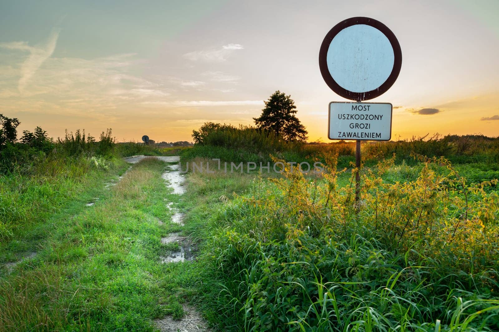 Sign by the road - A damaged bridge may collapse, Czulczyce, Poland