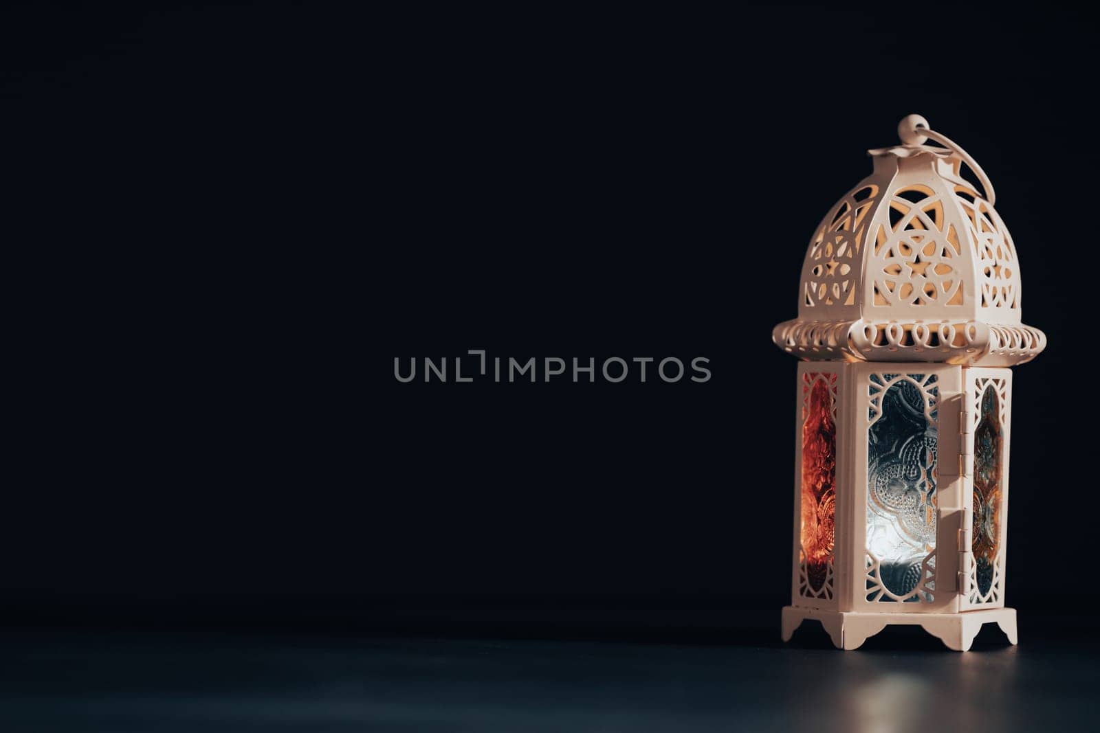Ramadan Kareem background. Ornamental Arabic lantern glowing at night