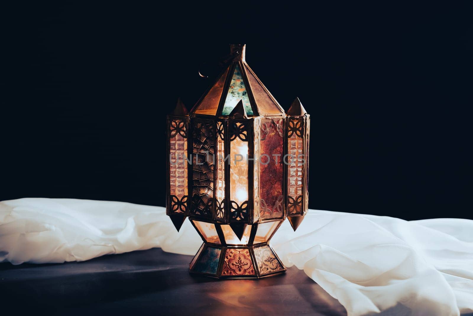 Ramadan Kareem background. Ornamental Arabic lantern glowing at night