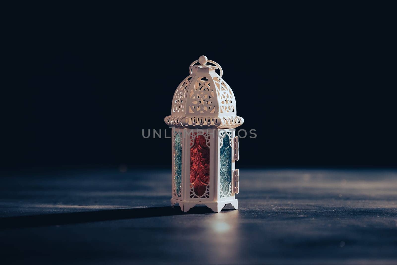 Ramadan Kareem background. Ornamental Arabic lantern glowing at night