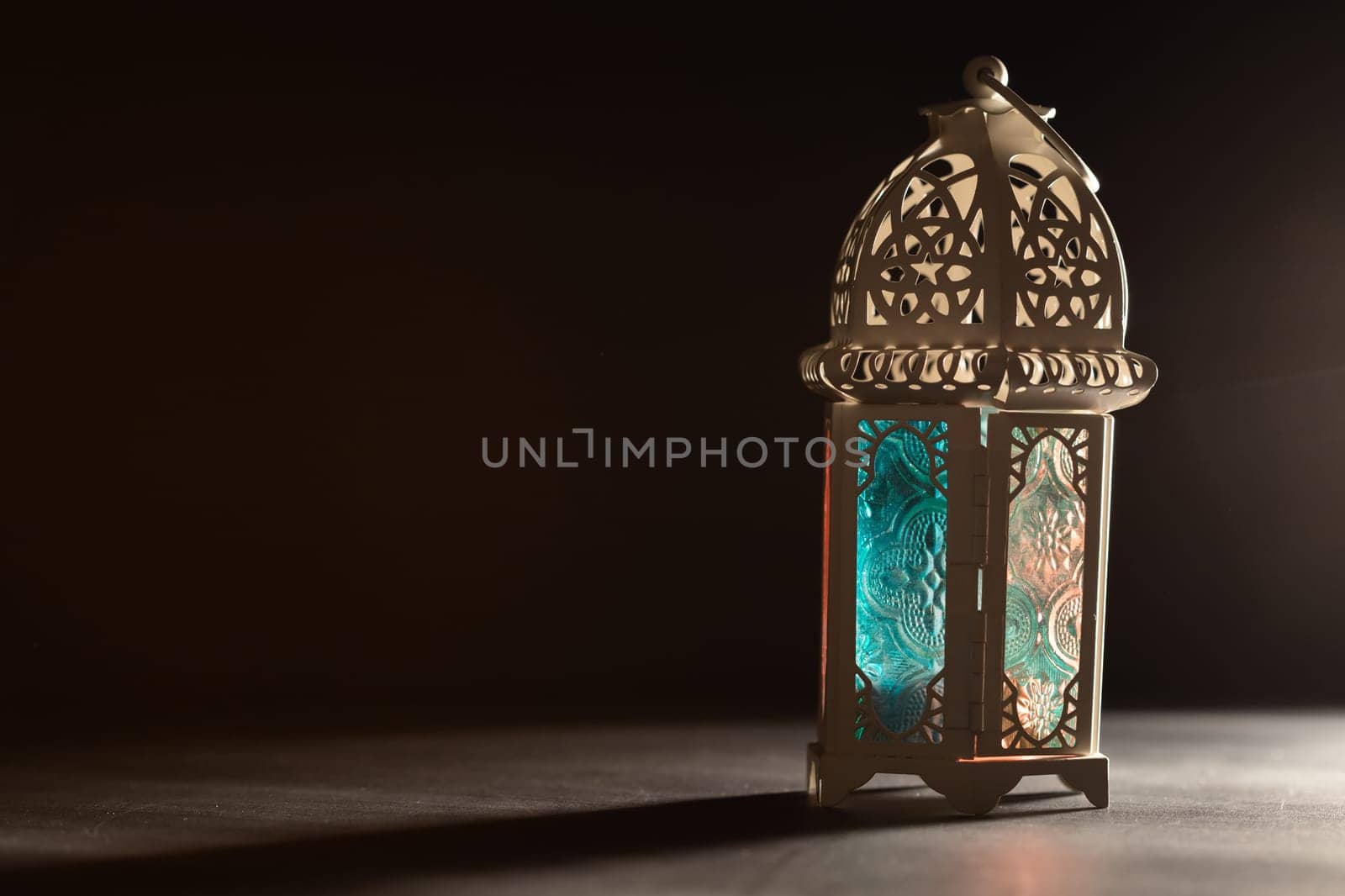 Ramadan Kareem background. Ornamental Arabic lantern glowing at night
