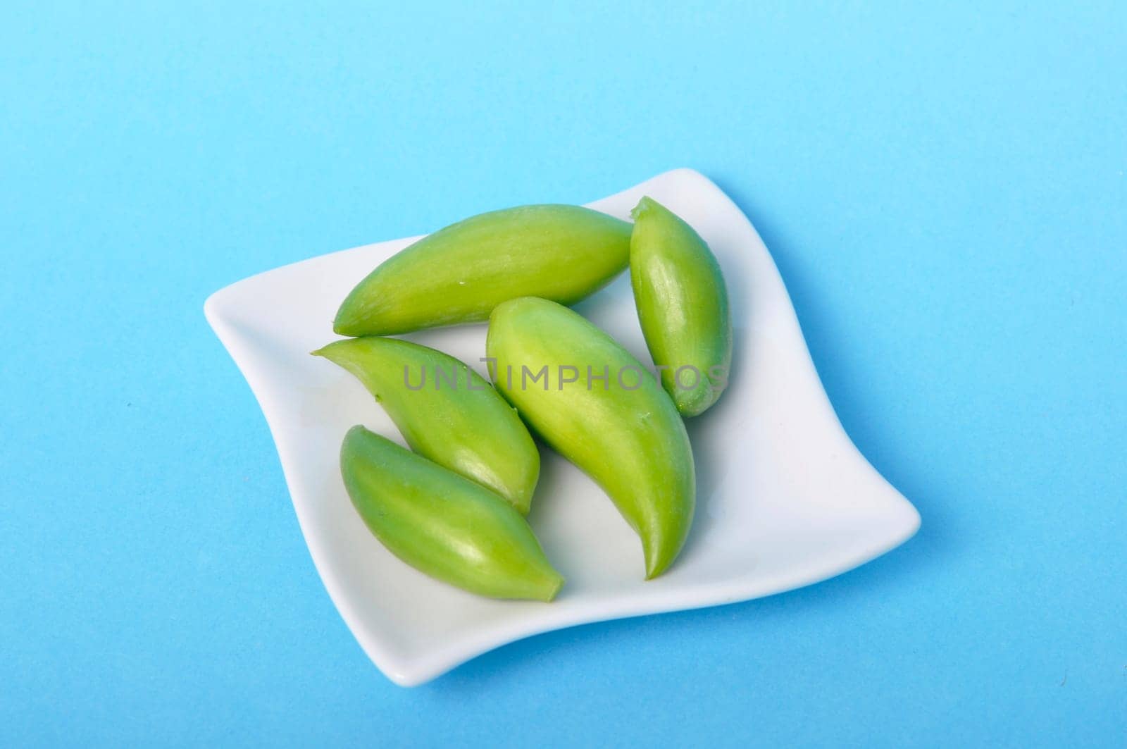 Achocha in a saucer on a blue background