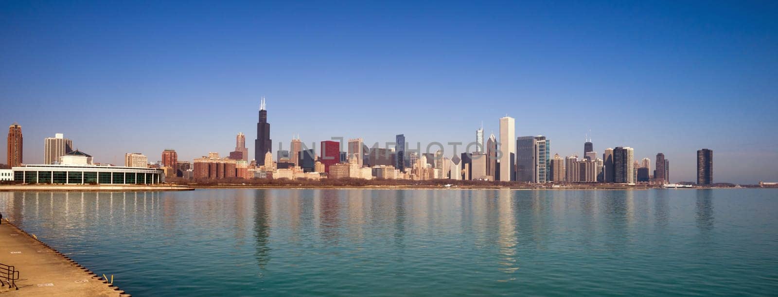 A beautiful pink sunrise lights the long downtown Chicago skyline