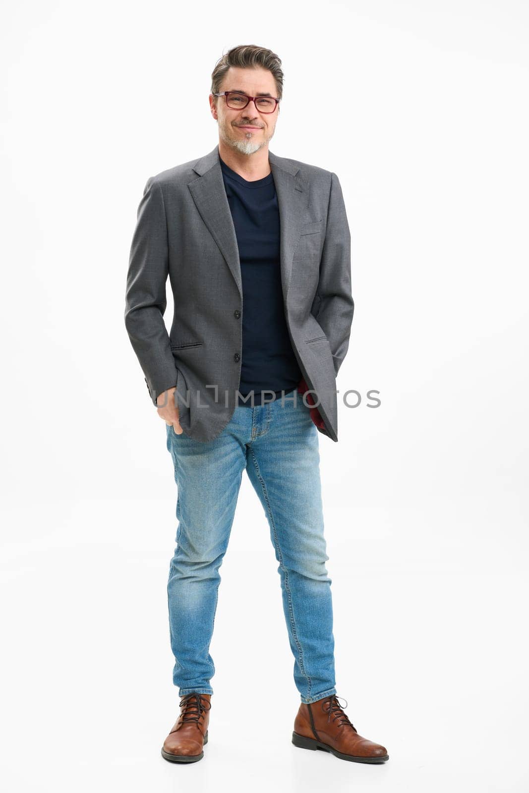 Middle age businessman in business casual. Entrepreneur in jeans and jacket. Mid adult, mature age man, happy smiling. Full length portrait isolated on white.