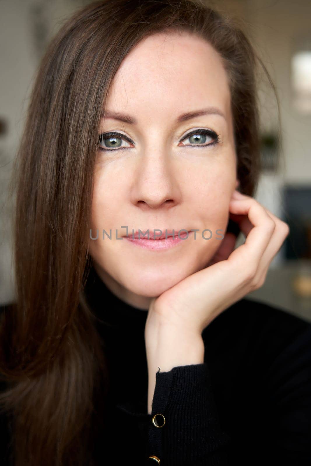 Portrait of a young white woman smiling feeling happy indoors.