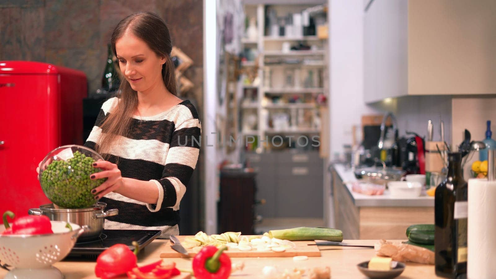 Young woman cooking in kitchen at home, healthy eating.