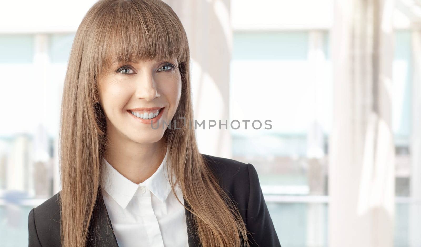 Portrait of happy young beautiful white businesswoman smiling. Copy space for text.