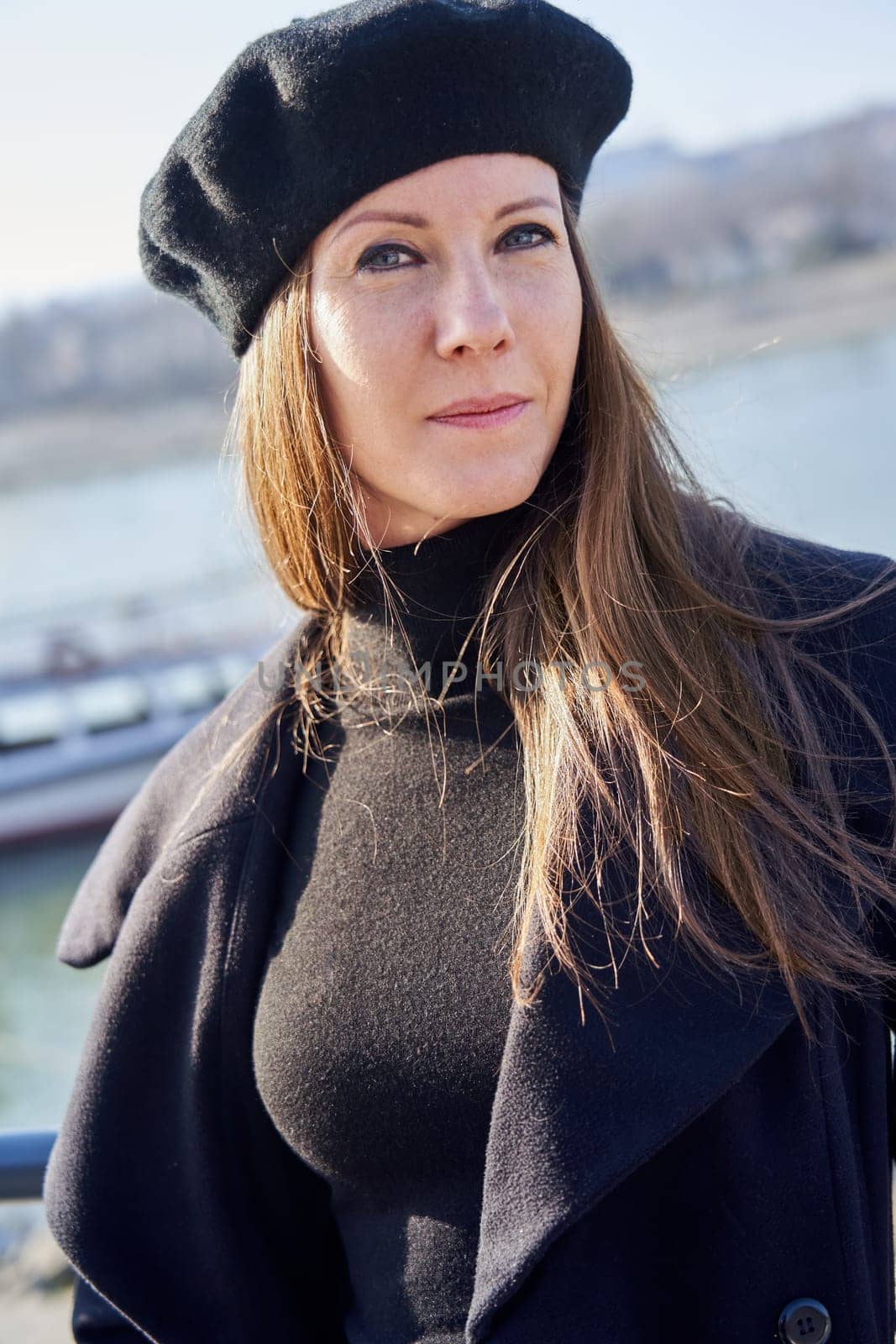 Portrait of elegant french woman outdoor wearing black clothes.