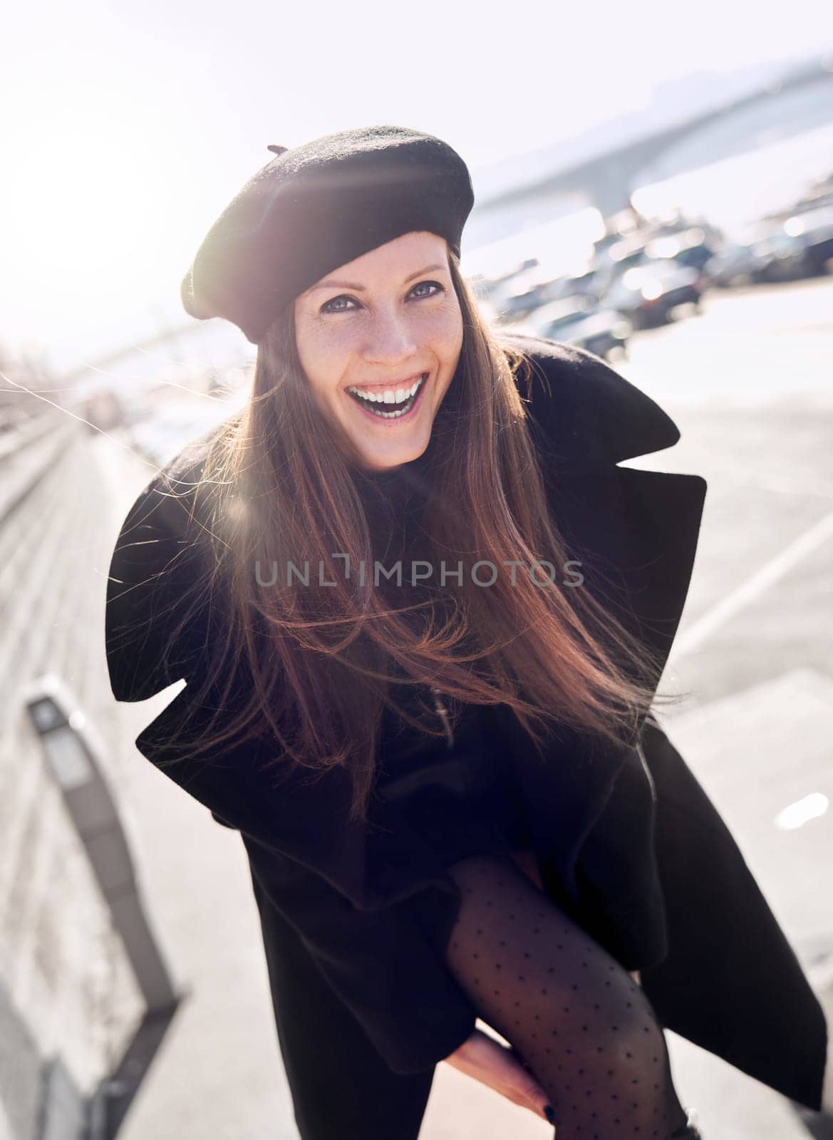 Portrait of happy french woman outdoor wearing black clothes, smiling.