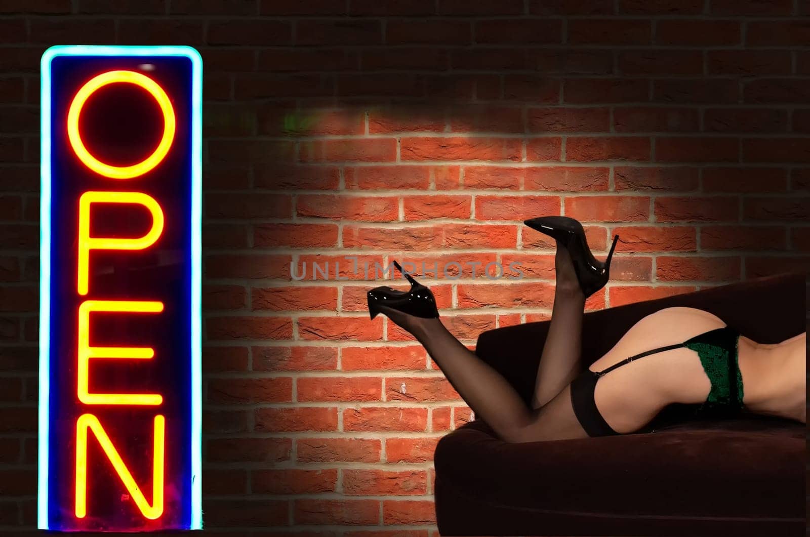 Escort, prostitute or sugar babe lies on the sofa with long legs and sexy high heels. Prostitution, sex work or sugar dating concept. Stripper or paid wife. Erotic body in the bar