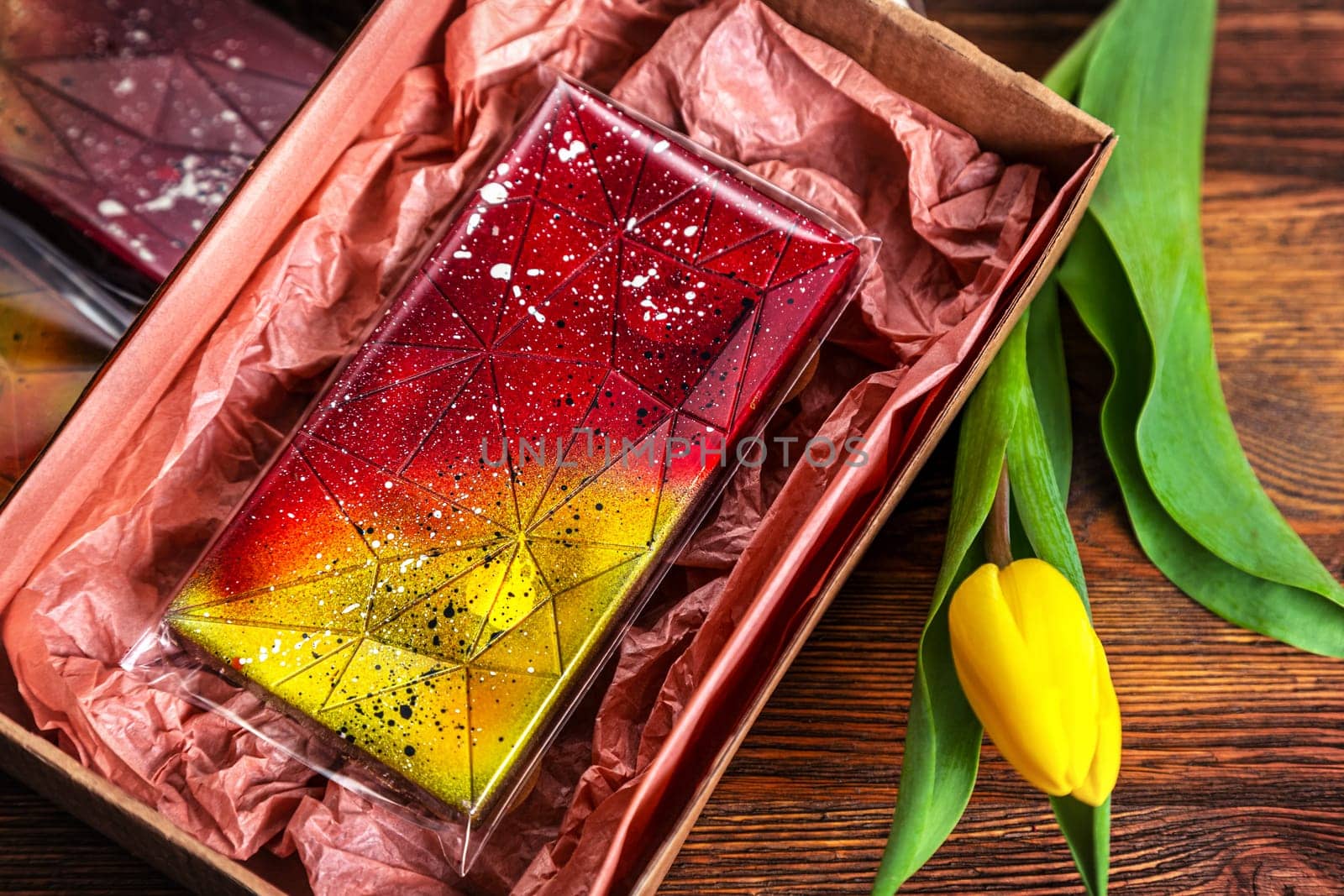 set of real Belgian handmade chocolate with berries and nuts using natural dyes on a dark background