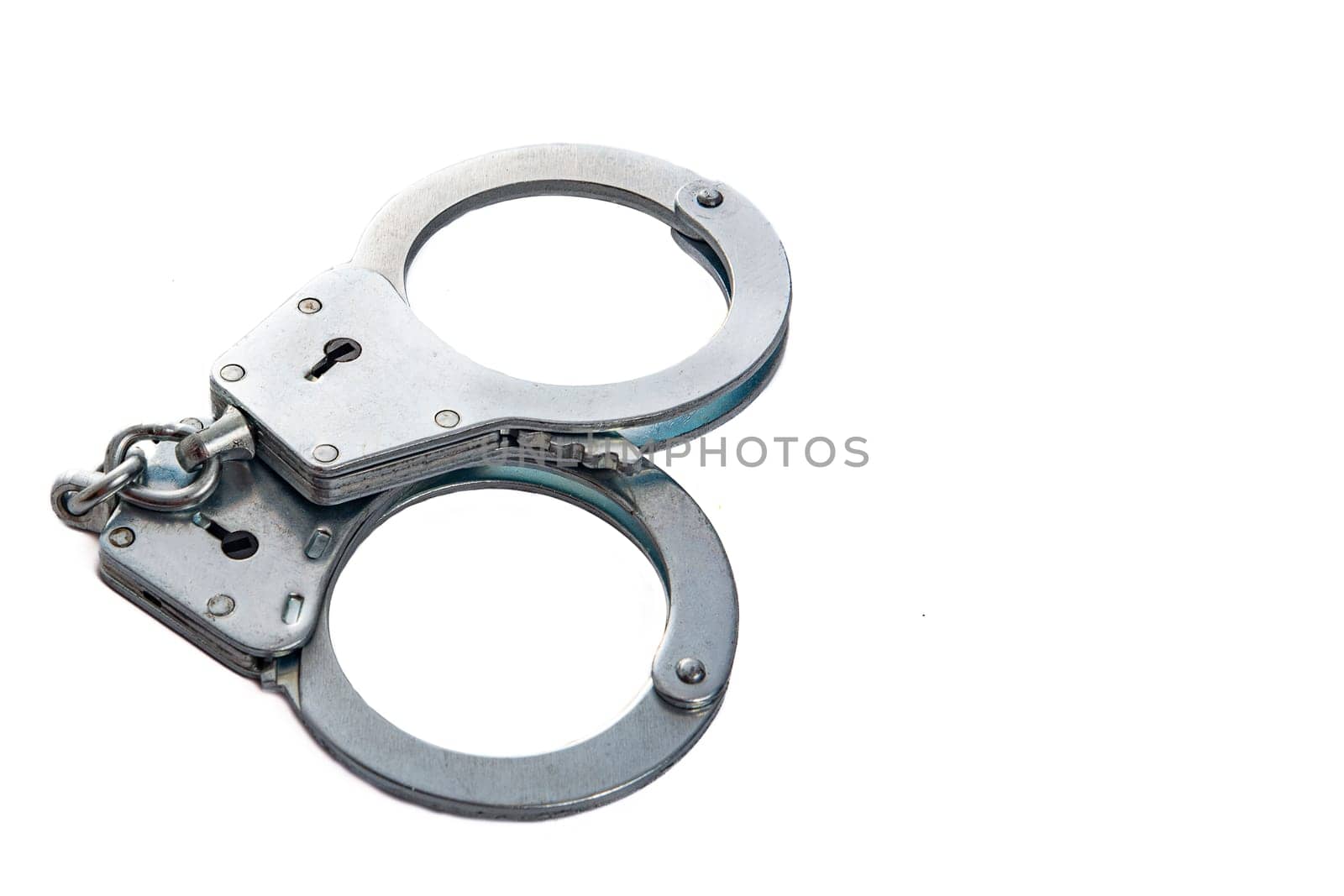 Metal handcuffs on a white isolated background, copy space. High quality photo