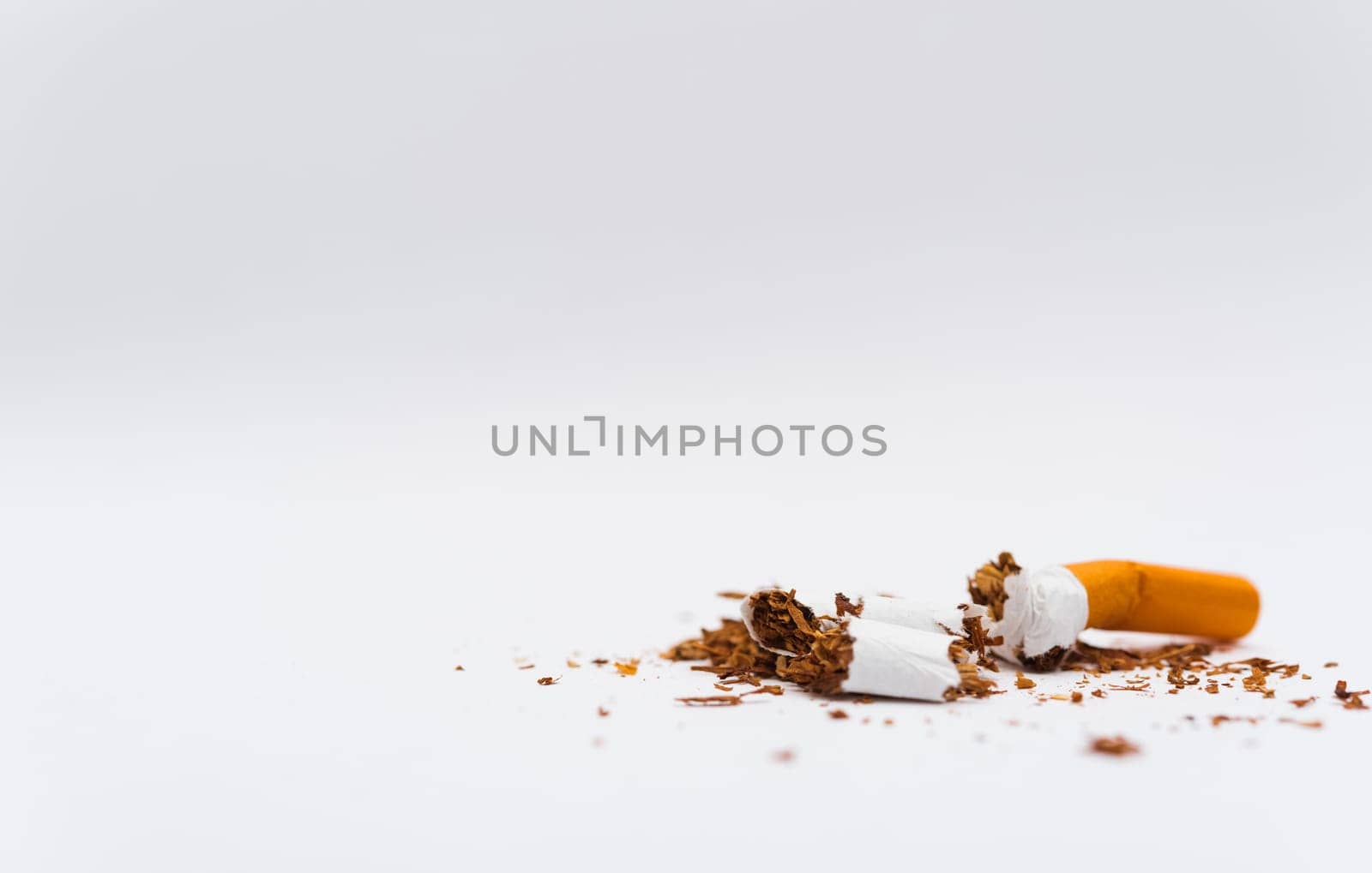 31 May of World No Tobacco Day, no smoking, close up of broken pile cigarette or tobacco STOP symbolic on white background with copy space, and Warning lung health concept