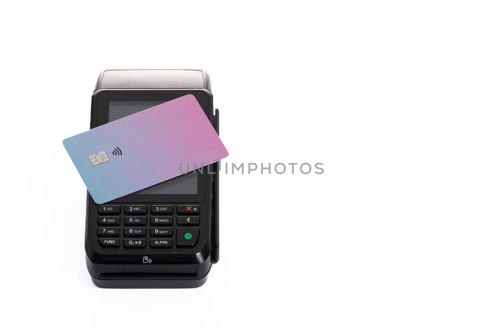 the plastic card lies on the payment terminal with a white isolated background. High quality photo