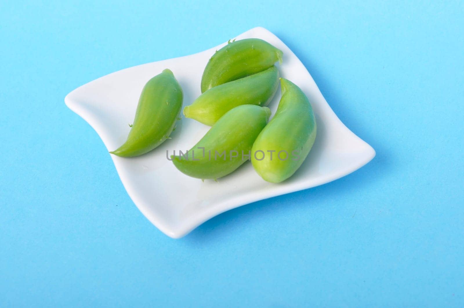Achocha in a saucer on a blue background