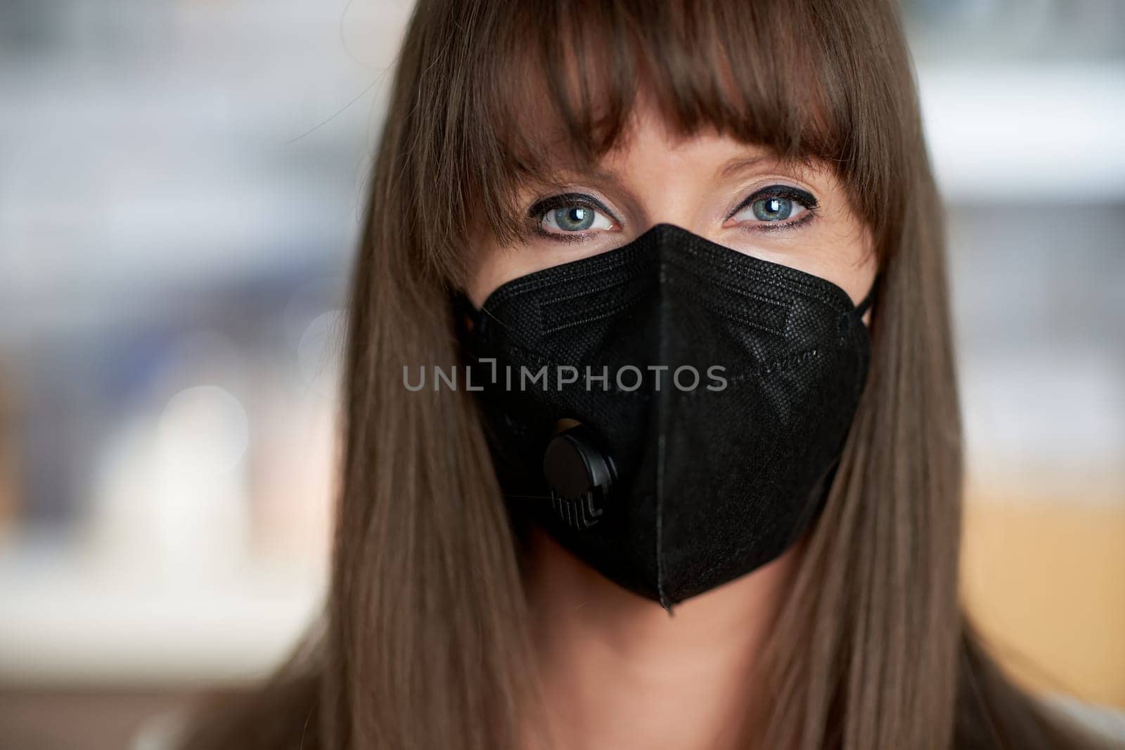 Coronavirus - Closeup portrait of beautiful young women in black face mask.