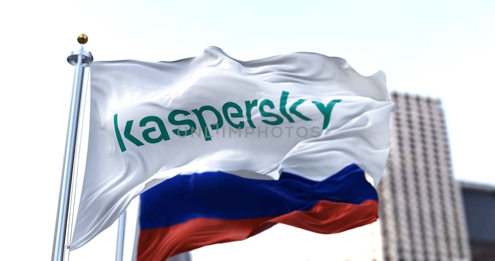 Moscow, RUS, March 2022: white flag with the logo of Kaspersky Lab waving in the wind with the Russian flag blurred in the background. Kaspersky is a Russian computer security software company