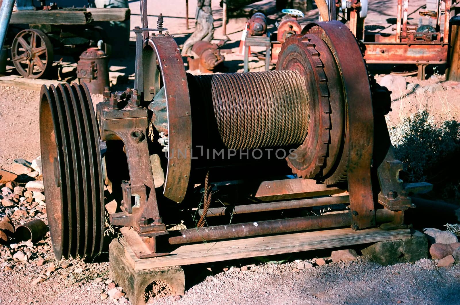 Old rust mining wench with rusty cable.