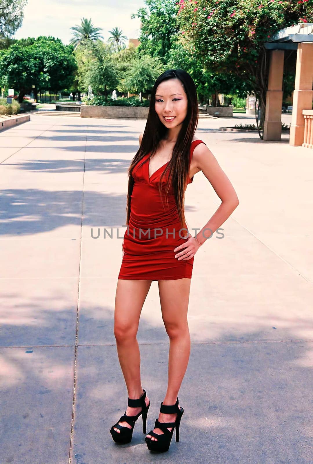 A lovely Asian female model posing outdoors