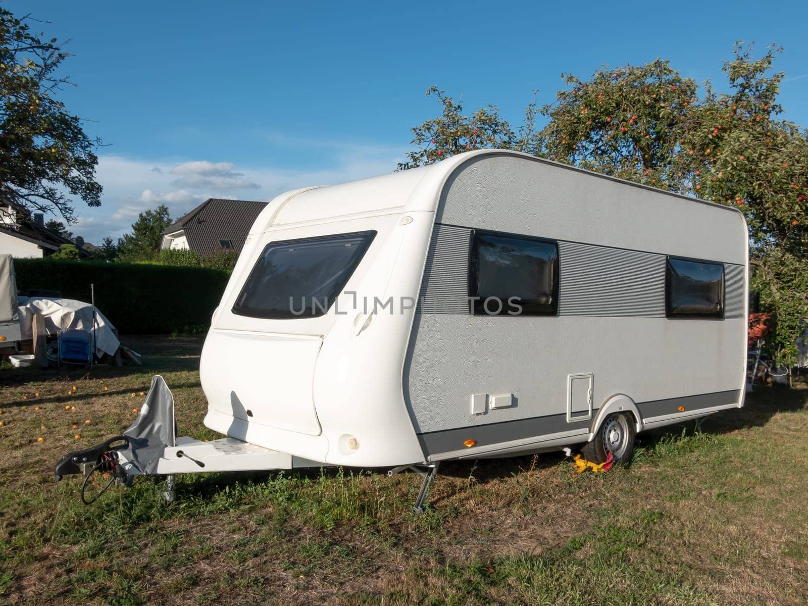 Parked caravan in autumn on a meadow ready to travel
