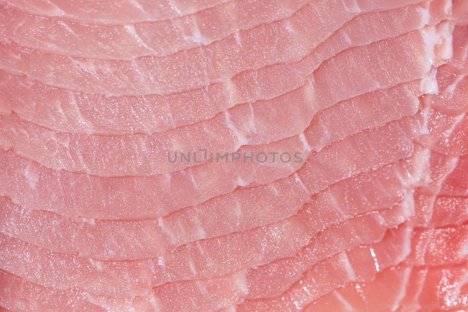 Closeup top view pieces raw meat of fresh pork slices are sliced into thin strips stacked on top of each other