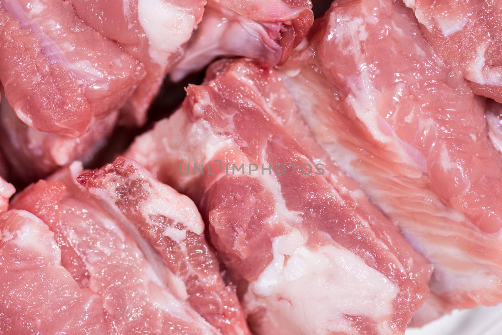 Close up top view pack pieces raw meat of pork loin on bone, fresh red pork with white fat of pork rib, Cut into pieces and put them in a row
