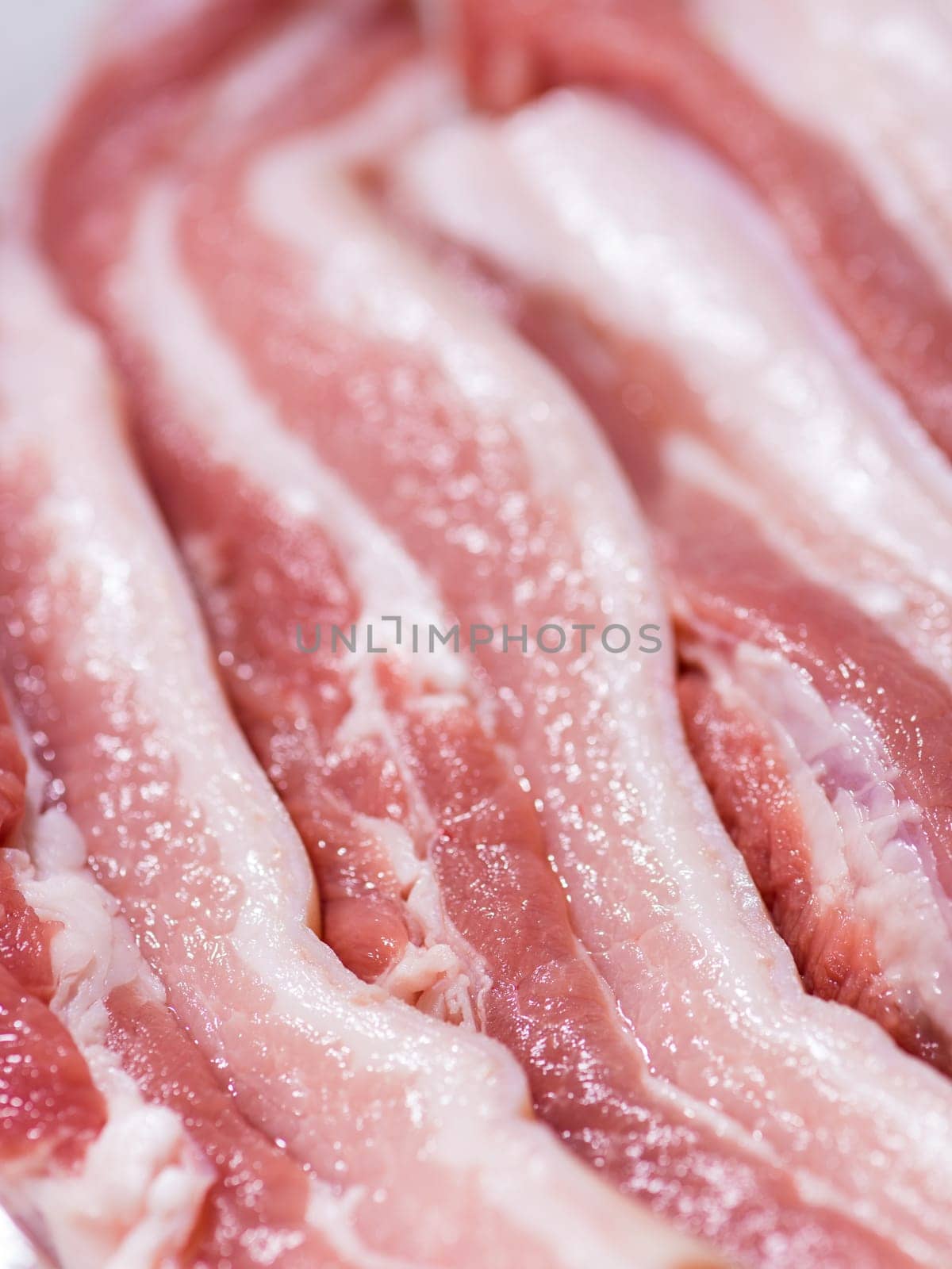 Closeup top view pieces fresh raw meat of pork belly with white fat and red pink meat