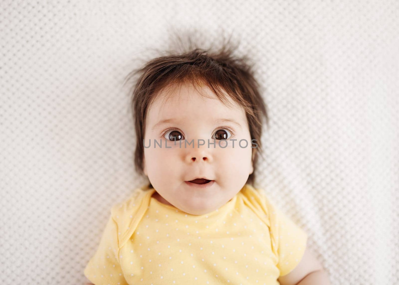 Cute little baby lying on the white blanket. Concept of childhood and new life.