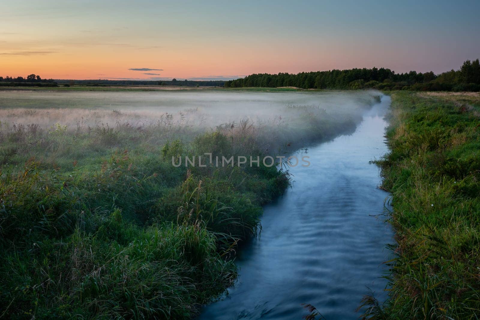 Fog over the meadow by the Uherka river, view after sunset, Czulczyce, Poland