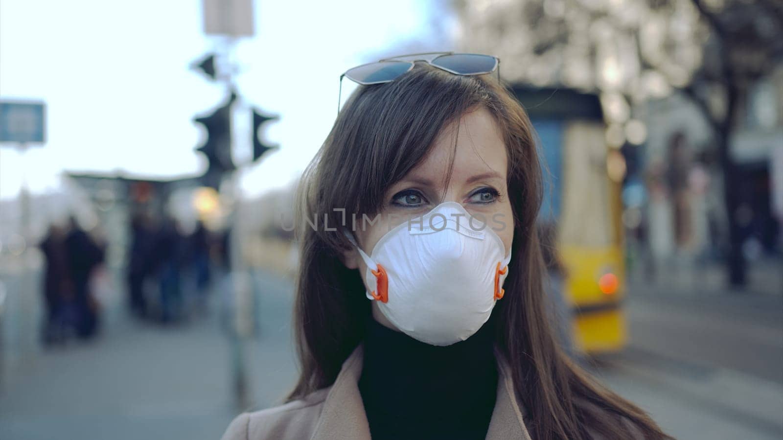 Covid-19 coronavirus protection - Woman in protective face mask in an empty european city.