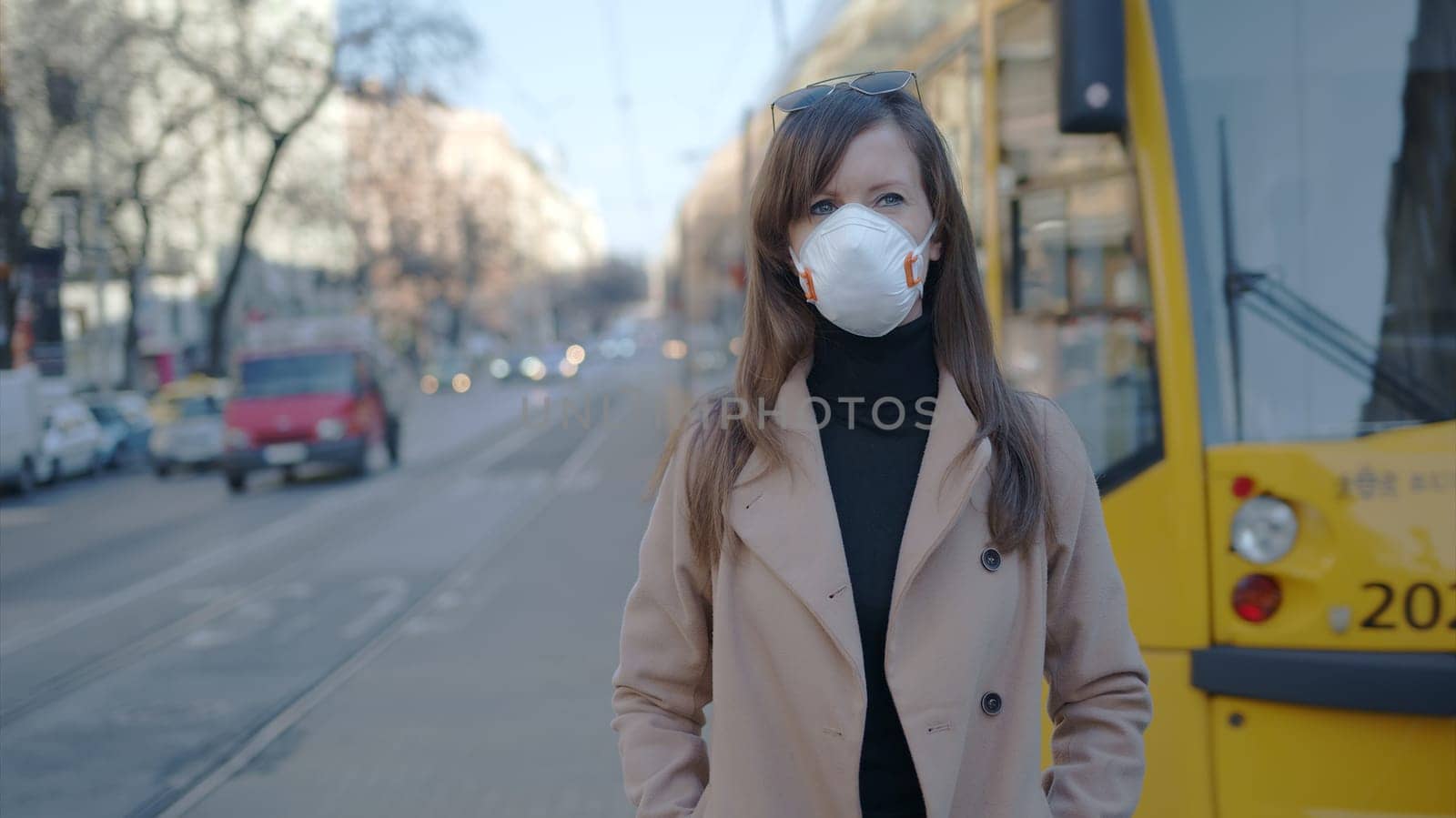Coronavirus disease - woman wearing face mask in public to protect herself from the covid-19 virus.