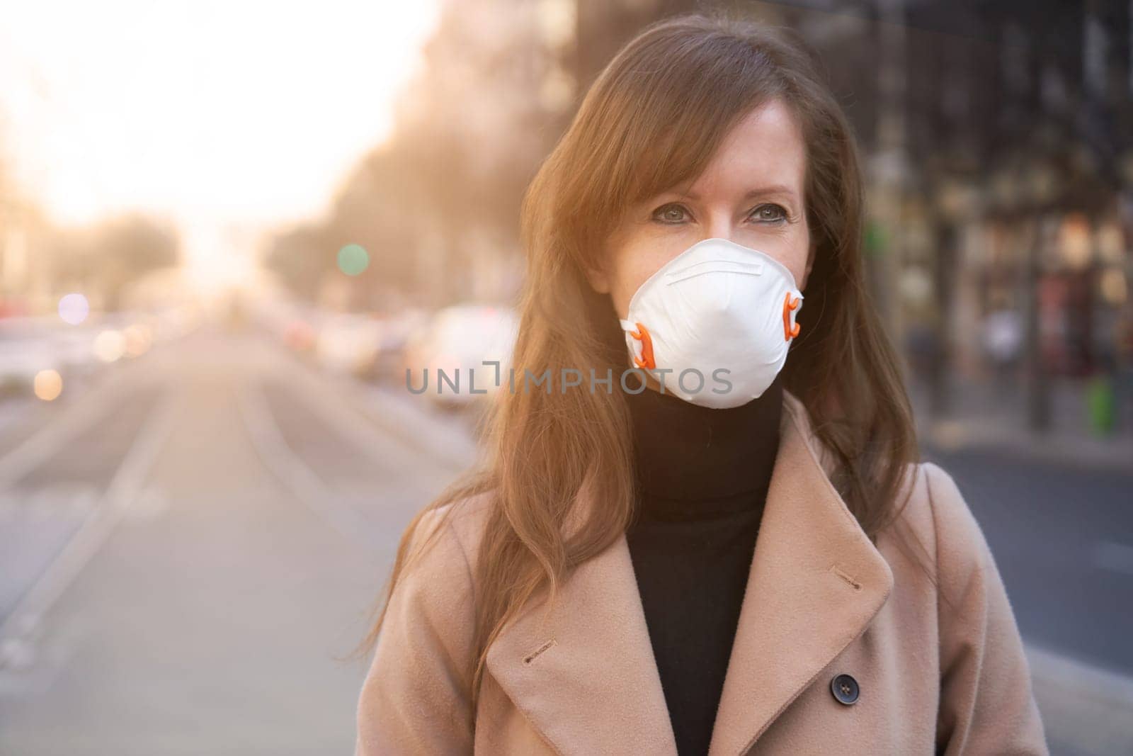 Coronavirus disease - woman wearing face mask in a public to protect herself from the covid-19 virus.