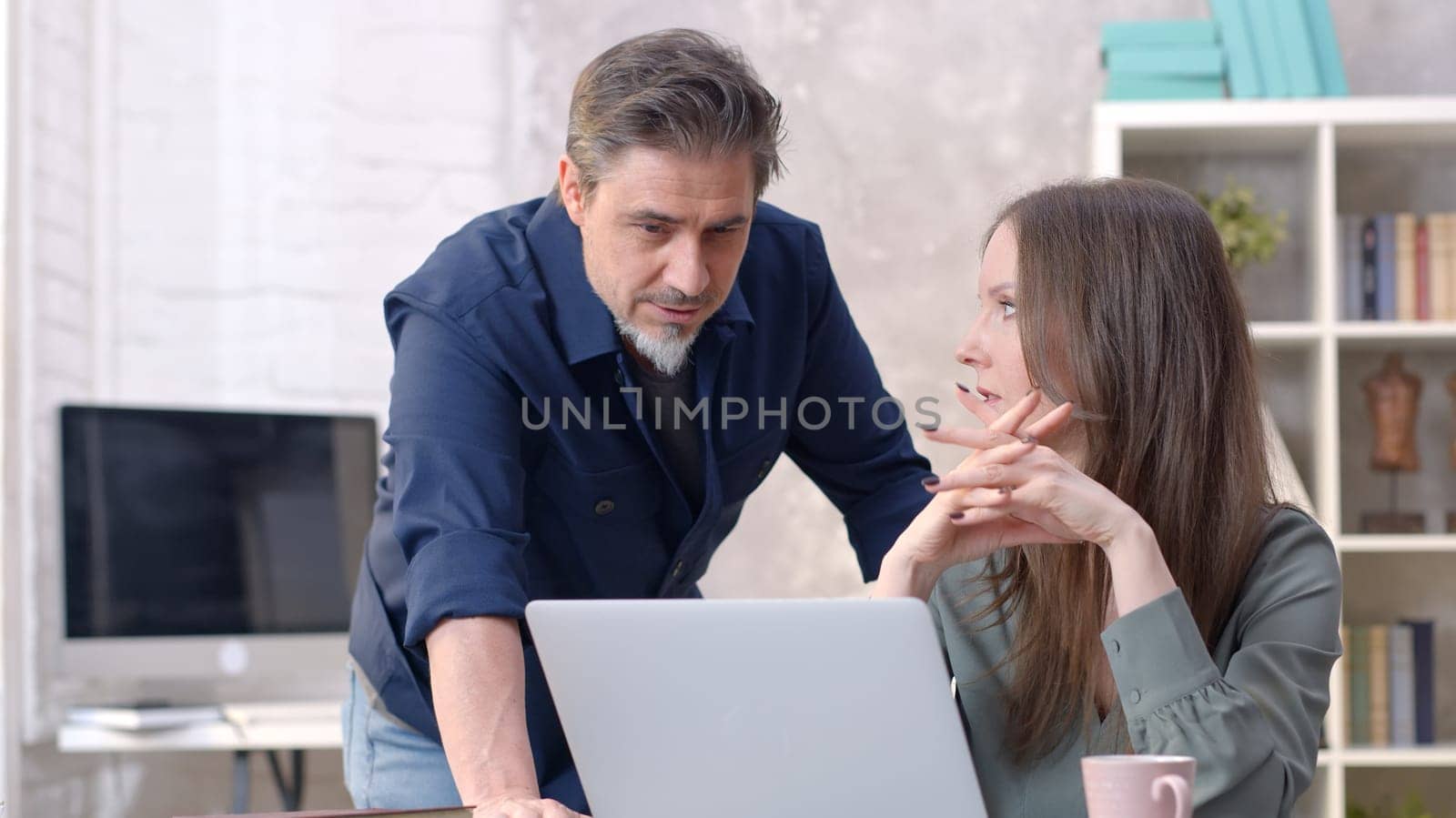 Business people working in office with laptop computer. Couple working from home at desk. Talking, meeting, cooperation, entrepreneurs, advisor.