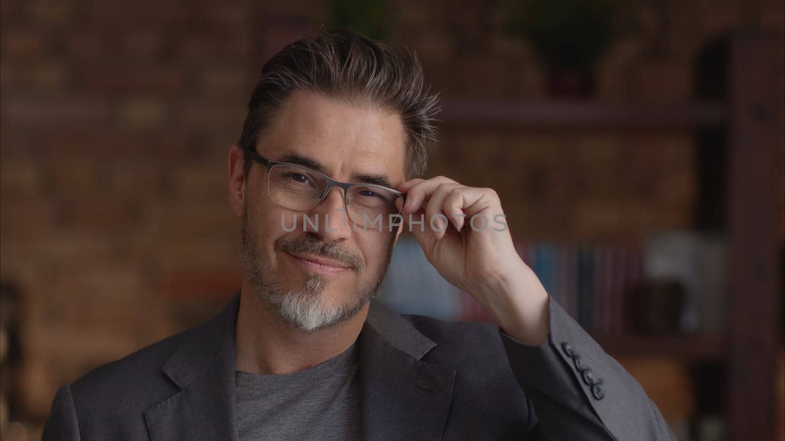 Confident businessman smiling in glasses. Portrait of mature age, middle age, mid adult man in 50s, happy confident smile. Copyspace.
