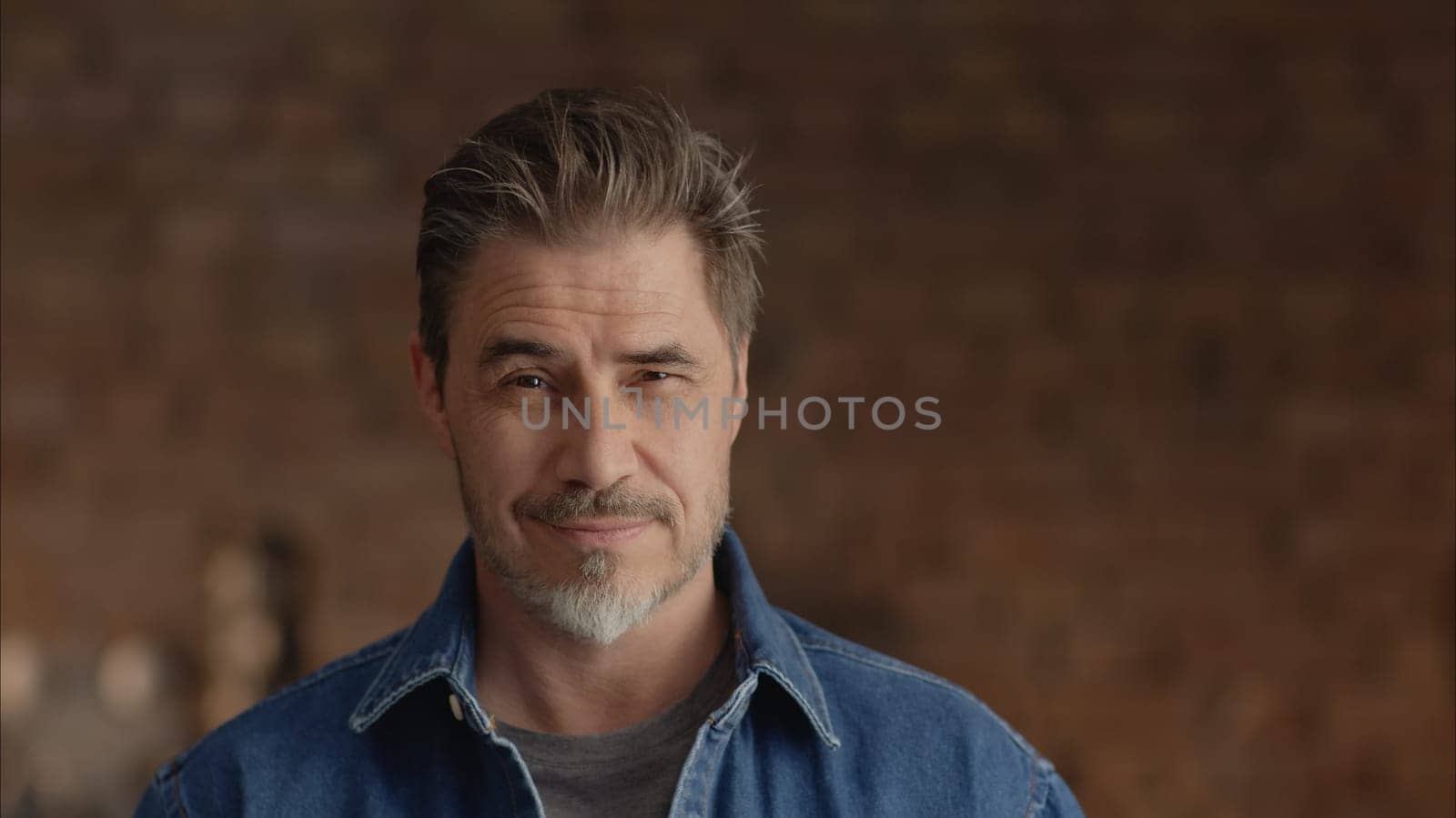 Portrait of mature age, middle age, mid adult man in 50s, happy confident smile. Copyspace.