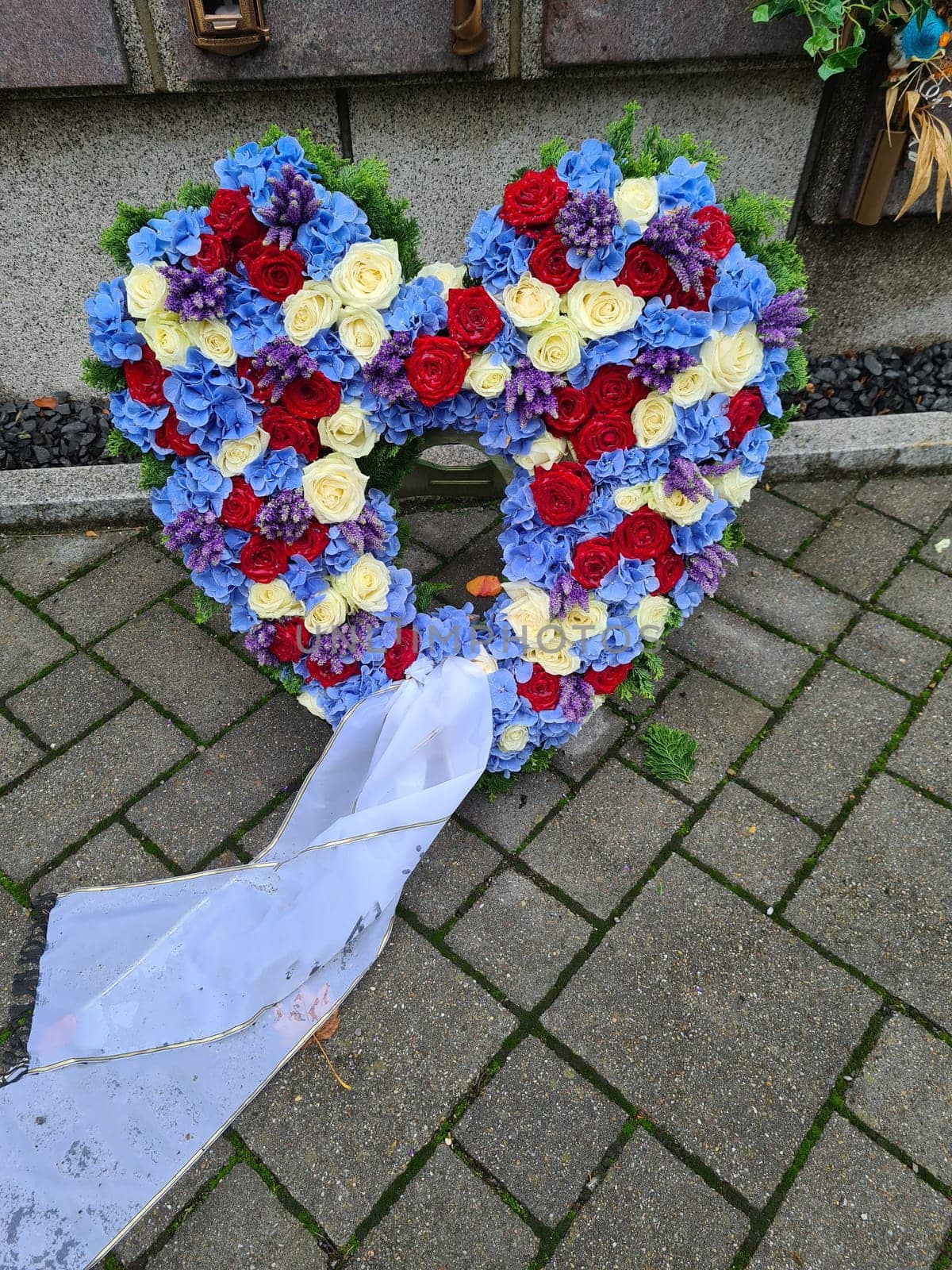 Heart of roses in front of a grave
