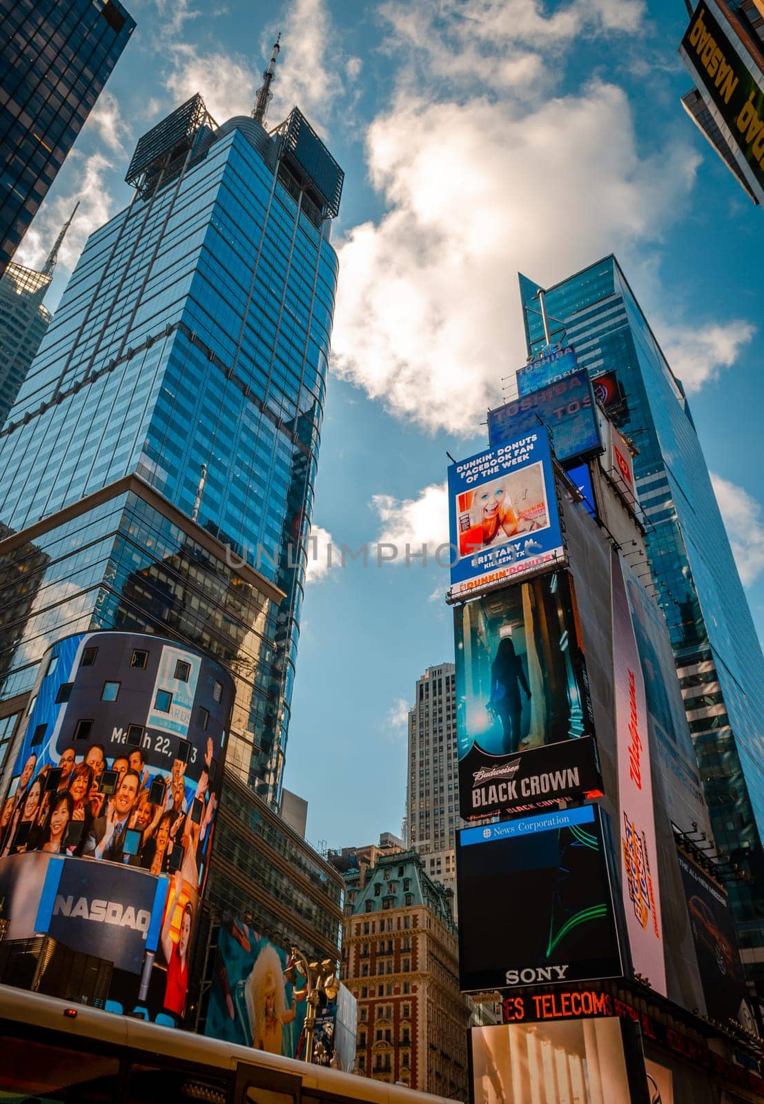 Time Square Skyscraper with advertisement scoreboards on the buildings, low angle view, vertical