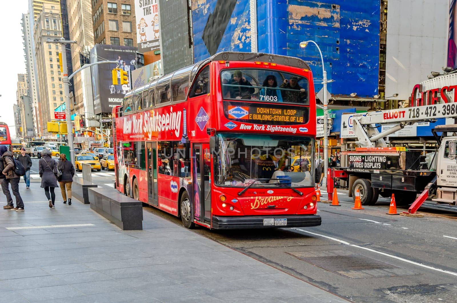 Red New York Sightseeing Bus parked at Time Square, lots of Tourist sitting in it, Time Square New York City, horizontal