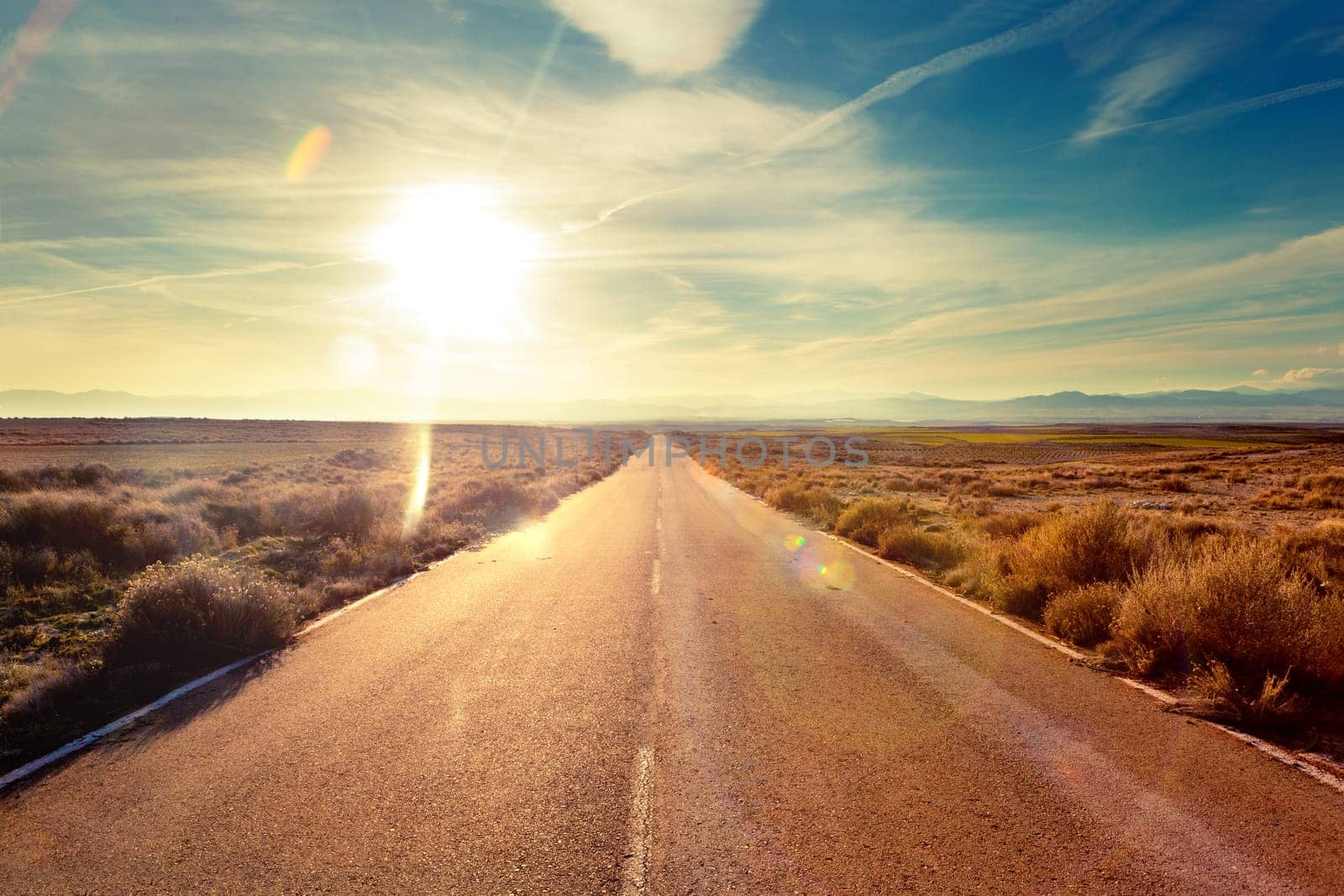 Road through landscape. Road and car travel scenic and sunset.