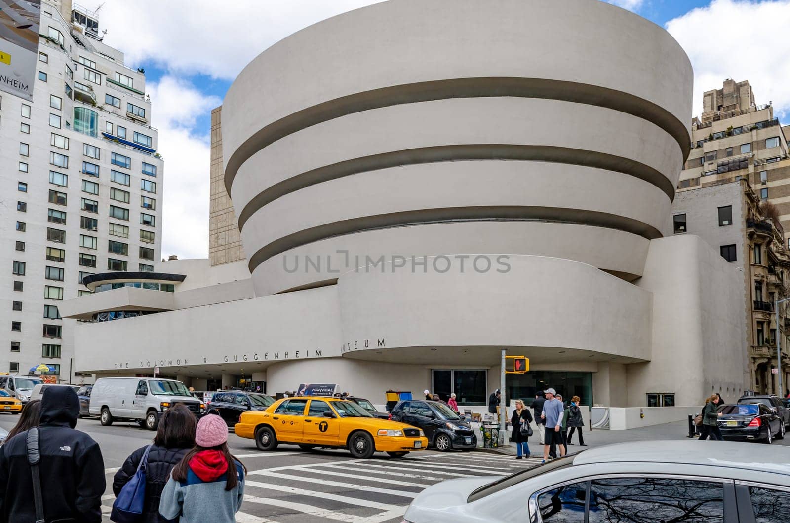 Solomon R. Guggenheim Museum, New York City, with traffic and crosswalk in the forefront during daytime in winter, view from low angle, horizontal