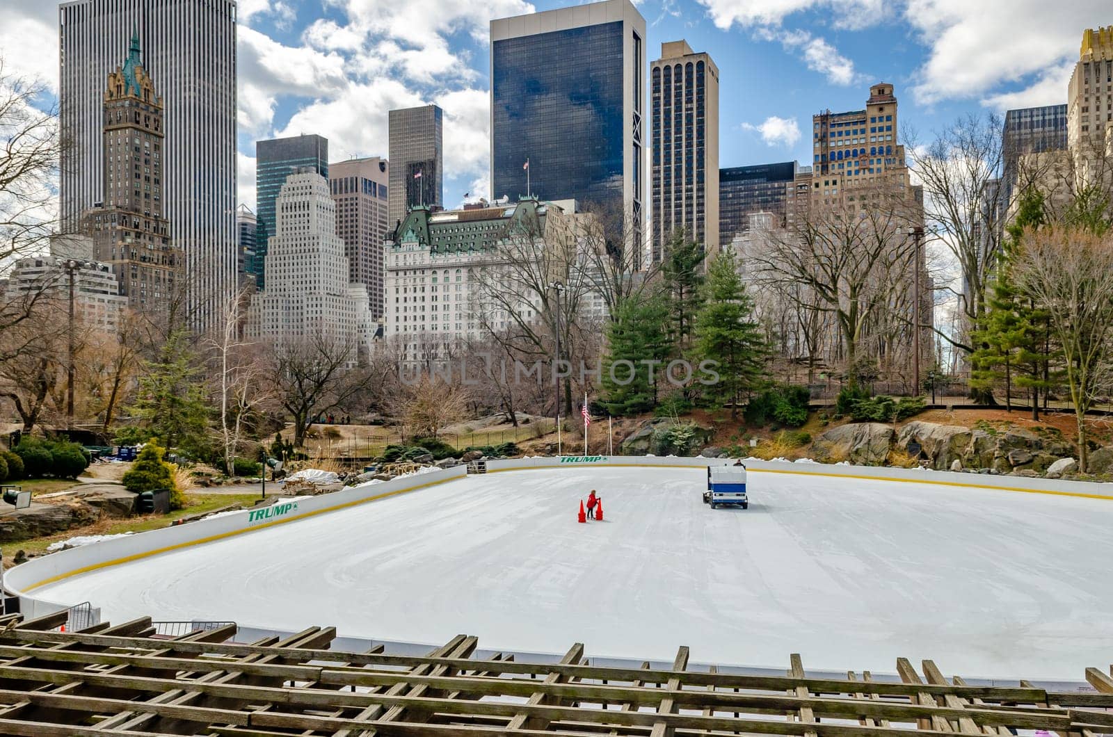 Wollman Rink during winter with no people on the ice as it gets renewed, skyline of Manhattan, great weather during daytime, New York City, horizontal