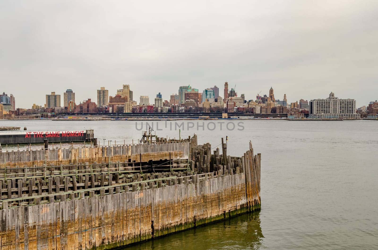 Brooklyn Skyline with Staten Island Ferry Battery Maritime Building Slip 5 wood jetty in forefront, during winter, horizontal