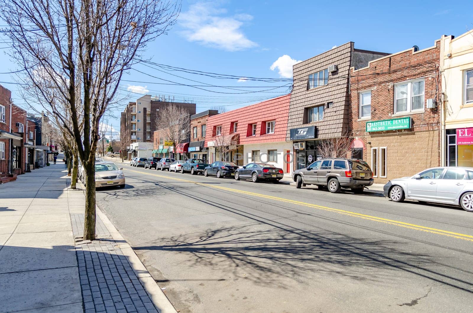 Retail Stores aesthetic dental, hair studio, Kumon, Tailor at Cliffside Park with parked cars in the forefront, New Jersey, during a sunny winter day, horizontal
