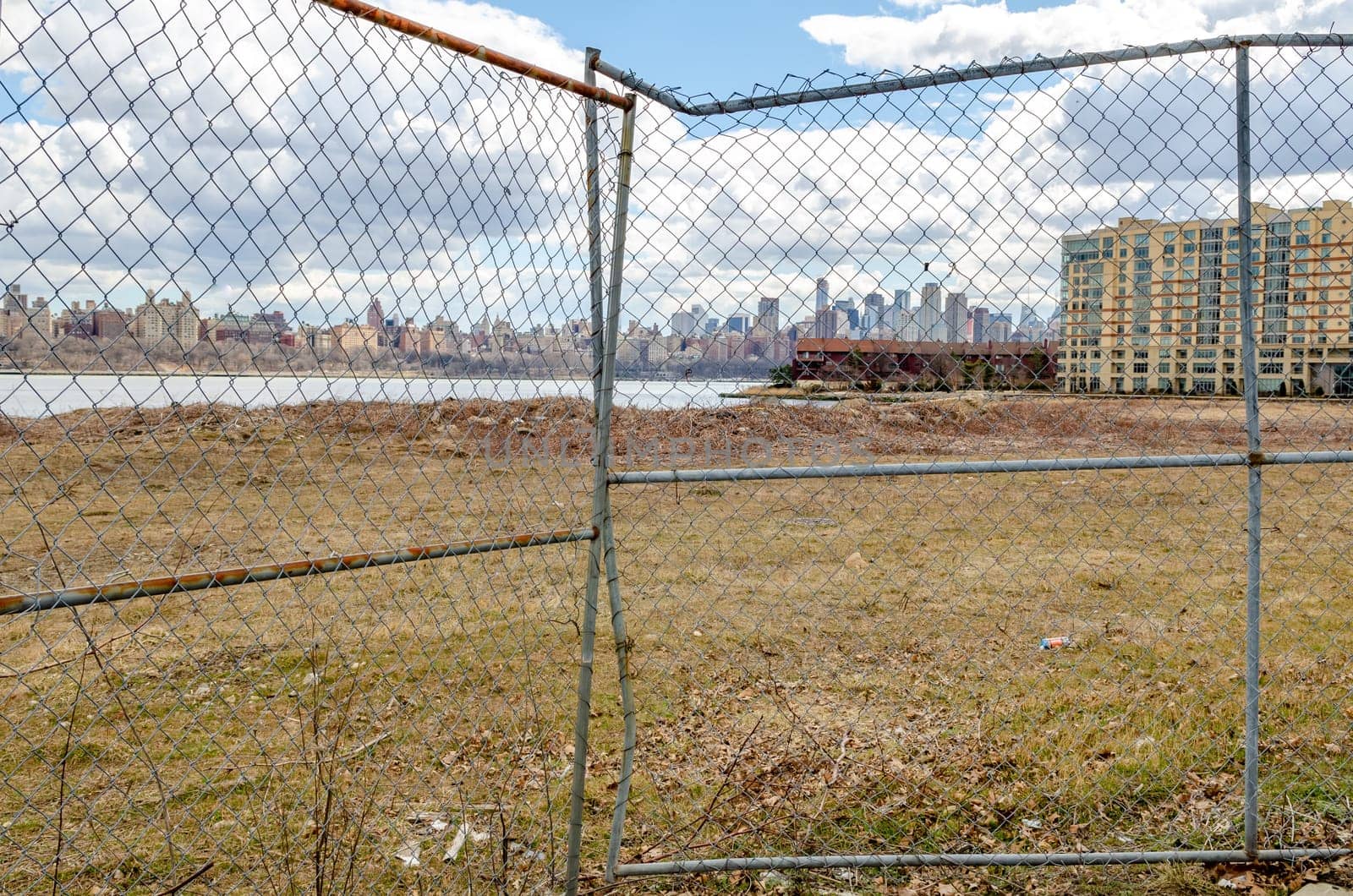 View of Manhattan with Hudson river, Construction area fence in the forefront, view from North Bergen, New Jersey, during a sunny winter day, horizontal